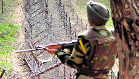 An Army jawan stands guard on the LoC in Nowshera sector in Rajouri district.