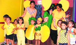 Children of ABC Montessori School celebrate mango day in Ludhiana on Tuesday.