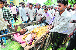 Rescuers transport bodies of victims of the ferry disaster to a hospital in Goalpara district of Assam, about 200 km from Guwahati city, on Tuesday