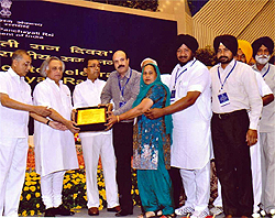 Chairperson of the Bathinda Zila Parishad, Rajwinder Kaur, and deputy CEO Rajindra Singh Batra receive the Best District Panchayat award for the year 2011-12 under the Panchayat Empowerment and Accountability Incentive Scheme (PEAIS) in the state of Punjab. The award was given away by the Union Rural Development Minister, Jairam Ramesh and the Panchayati Raj Minister, Kishore Chandra Deo