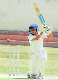 A player hits the ball during a cricket match at DAV-8 in Chandigarh