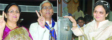 Newly elected Mayor and Deputy Mayor of the South Delhi Municipal Corporation Savita Gupta (L) and Bir Singh flash victory signs. (Right) Congress councillor and cricketer Virender Sehwags sister, Anju Sehwag, casts her vote during the election for Mayor at the Civic Centre in New Delhi on Wednesday.