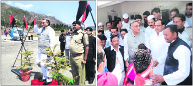 Chief Minister Vijay Bahuguna takes the salute on his arrival at the Naini Saini airport; and (right) Vijay Bahuguna and state Revenue Minister and Congress chief Yashpal Arya being greeted by party workers on their visit to Pithoragarh on Wednesday.