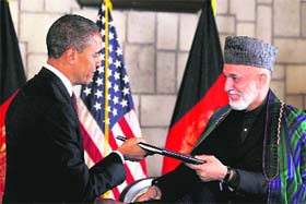 President Barack Obama and Afghan President Hamid Karzai sign a strategic partnership agreement