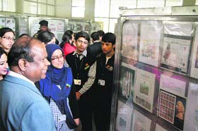 Chief Post Master General, J&K Circle, John Samuel takes a look at stamps at Srinagar British School on Wednesday
