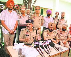 Ludhiana Range DIG MF Farooqi along with SSP Mandeep Singh and other officers addresses a press conference in Fatehgarh Sahib on Wednesday