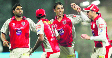 Kings XI Punjab's Azhar Mahmood (2ndR) celebrates with teammates the wicket of Chris Gayle during their match against Royal Challengers Bangalore in Bengaluru on Wednesday. Kings XI won by 4 wickets.