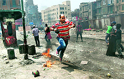 A photographer runs for cover during clashes in Cairo on Wednesday