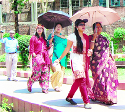 Walkers arm themselves with umbrellas and caps to fight the rising temperature in Amritsar.