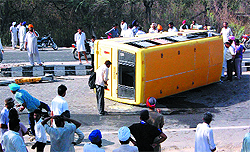 The Sanawar Public School bus that met with an accident near the Ambuja cement factory; An injured school kid (below) receives medical attention at the Civil Hospital, Bathinda, on Thursday