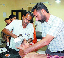 An injured school kid  receives medical attention at the Civil Hospital, Bathinda, on Thursday.