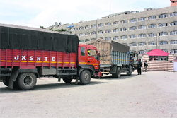 Trucks carrying official records from Jammu reach the civil secretariat in Srinagar. P