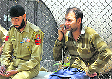 The man (right) whose brother was killed by his nephew, outside the mortuary at Government Medical College and Hospital in Jammu on Thursday. 