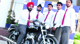 Students of CT Polytechnic pose with the modified motorcycle in Jalandhar on Thursday.