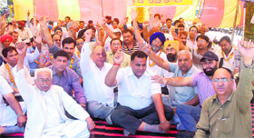 Members of the Depot Holders Association protest during their hunger strike in front of the office of the Deputy Commissioner in Jalandhar on Thursday.