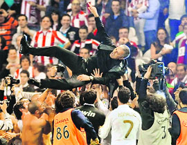 Real Madrids players toss coach Jose Mourinho after winning the match against Athletic Bilbao 3-0, on Wednesday. With this win Real won the league title for the first time since 2008. 