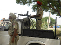 Police personnel keep vigil at the Guru Gobind Singh Refinery at Phulokhari in Bathinda o