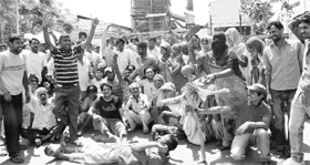 Door-to-door garbage collection workers protest at the main gate of Jaypee garbage processing plant near Dadu Majra on Friday.