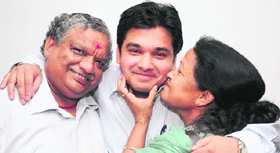 Piyush Singla gets a hug from his mother, as his father beams at their residence at Sector 36, Chandigarh. 