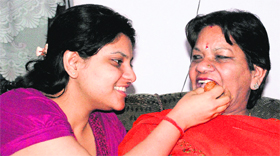 Sanyams sister and mother celebrate her success with sweets.