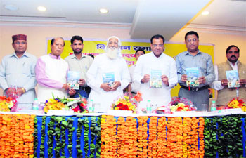 Revenue Minister Yashpal Arya (third from left) and environmentalist Sunder Lal Bhuguna release a book written by Chaman Lal Pardyot (second from right), a former IPS officer, at a function in Dehradun on Friday. 