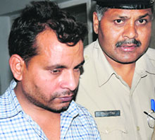 Travelling ticket examiner Manoj Kumar, booked for neglect of duty and attempt to murder, is produced in a court in Karnal.