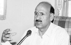 IPH Minister Ravinder Ravi addresses the media in Dharamsala on Friday.