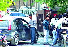Employees of parking contractor collect fee from visitors parking their vehicles at the District Administrative Complex