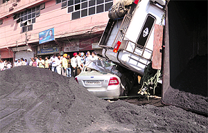 The car which was hit by a truck near Partap Chowk, Ludhiana, on Friday. The youth driving the car escaped unhurt