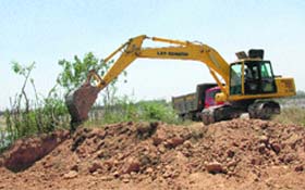 A crane being used to remove silt from the Sukhna Lake in Chandigarh on Saturday