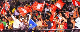 Kings XI Punjab supporters celebrate the wicket of Rajasthan Royals captain Rahul Dravid at the PCA stadium in Mohali on Saturday