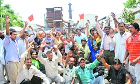 Door-to-door garbage collection workers protest in front of the processing plant near Dadu Majra on Saturday