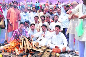Ganga Sabha members and teerth purohits of temples at Har-ki-Pauri perform yajna at Brahamkund in Haridwar on Saturday
