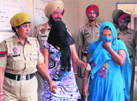 The accused in police custody in Jalandhar on Saturday. Tribune Photo: Malkiat Singh