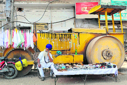A vendor sells wares in Amritsar on Saturday. Foreign corporate confidence in India has been sapped by government paralysis in enacting reforms to liberalise the still mainly inward-looking economy