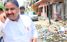 Darshan Kumar Garg calls up the MC Commissioner from in front of his house at Palsora in Sector 56 of Chandigarh on Sunday. 