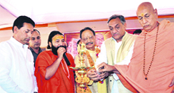 CM Vijay Bahuguna and former Chief Minister BC Khanduri light a lamp during the Bharat Mata Mandir function in Haridwar on Sunday. Also seen in the picture are Swami Satyamitranand Maharaj and Swami Harichetanand.