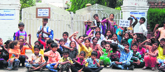 Children of Gujral Nagar residents protest outside the Deputy Commissioners residence in Jalandhar on Sunday. 
