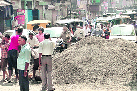 Construction material lying on the road blocks traffic outside Arya Senior Secondary School