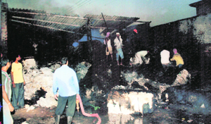 Firemen try to douse flames at Sainik Textiles Mills Private Limited near Ahmedgarh on Sunday.