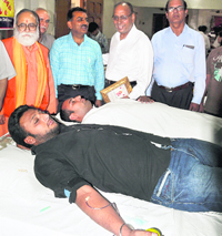Volunteers donate blood in Ludhiana on Sunday.
