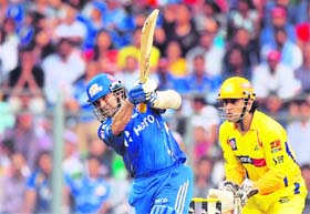 Mumbai Indians Sachin Tendulkar (L) plays a shot as Chennai Super Kings wicket-keeper Mahendra Singh Dhoni watches at the Wankhede Stadium in Mumbai on Sunday