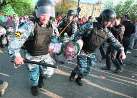 The Russian police detains an opposition supporter during a rally in Moscow on Sunday