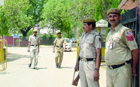 The police personnel outside the Delhi police training school where a constable was shot dead at Malviya Nagar in New Delhi on Monday. 