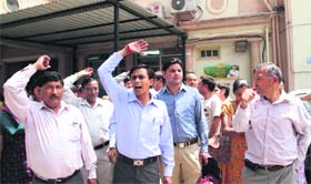 Lab technicians hold a protest in support of their demands at Doon Hospital in Dehradun on Monday