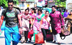 Devotees return after taking a holy dip in the Ganga on the occasion of Buddh Poornima at Har-Ki-Pauri in Haridwar