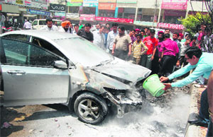 The car which caught fire in the parking lot of Nehru Shopping Complex in Amritsar on Tuesday. 