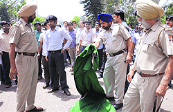 Policemen remove the carpets of protesting resident doctors (also seen in the photograph) at the PGI in Chandigarh on Tuesday