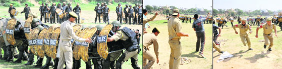 From left: A special squad of the JK Police makes a formation to control the rioters; comes under attack from stone-pelters and chases them down during a special training course in Jammu on Tuesday. 