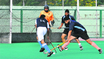Players in action during the final of the Guru Teg Bahadur Hockey Championship at KK Hakku Stadium in Jammu on Tuesday. 